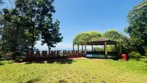 Apsarakonda Park signpost with a scenic backdrop of lush greenery and the sea