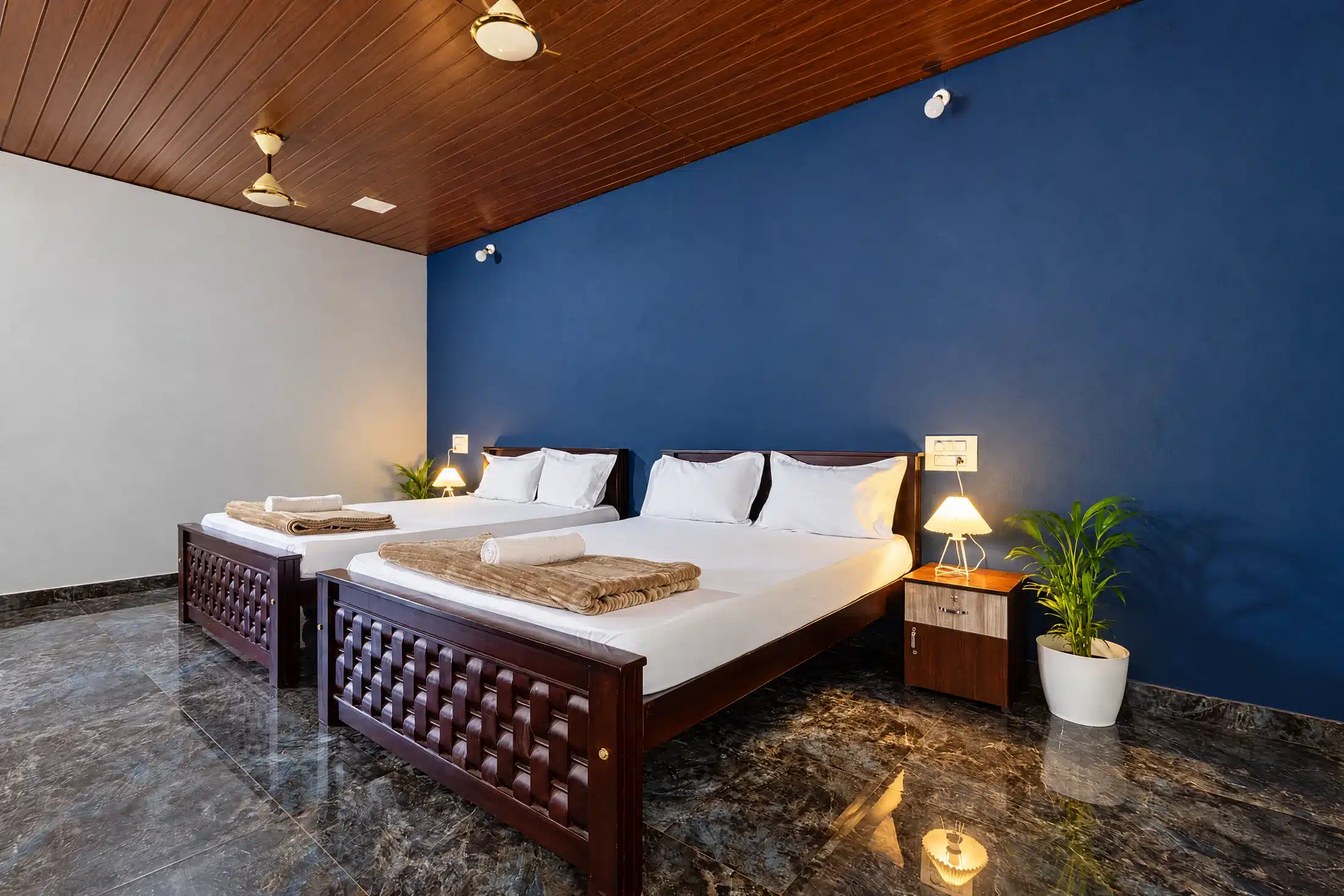 Family room interior detail with two beds and bedside lighting