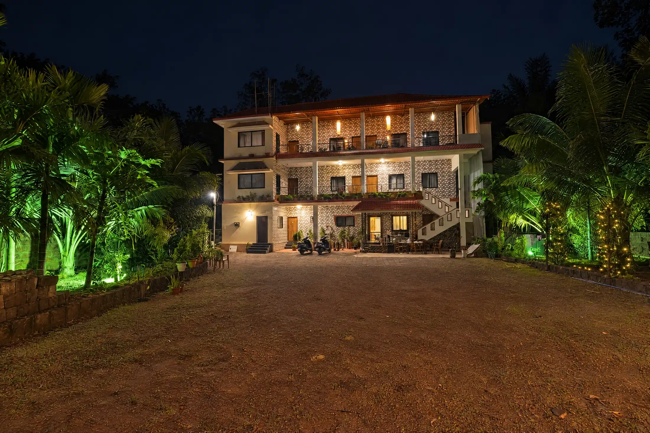 Home Lopez Paradise Homestay illuminated at night in Honnavar
